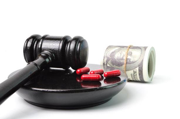 Gavel with money and pills